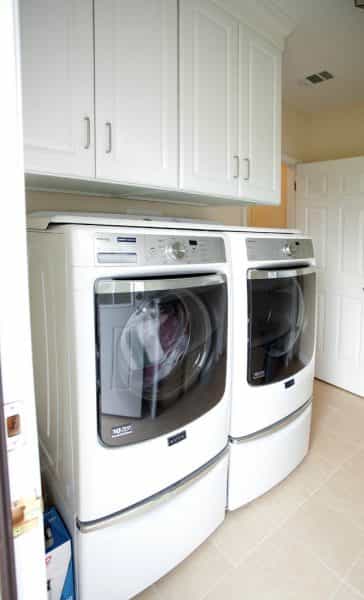 The laundry room in this Washington Crossing, PA home keeps linens and washing supplies out of sight.